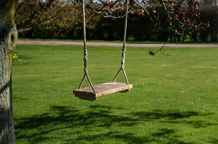 Daughter And Her Father On A Swing